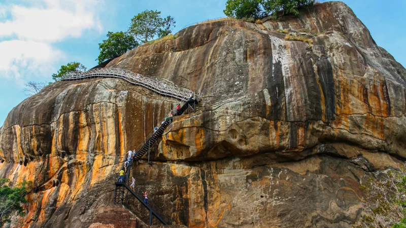 People Climbing Stairs Mounted on the Rock Mountain