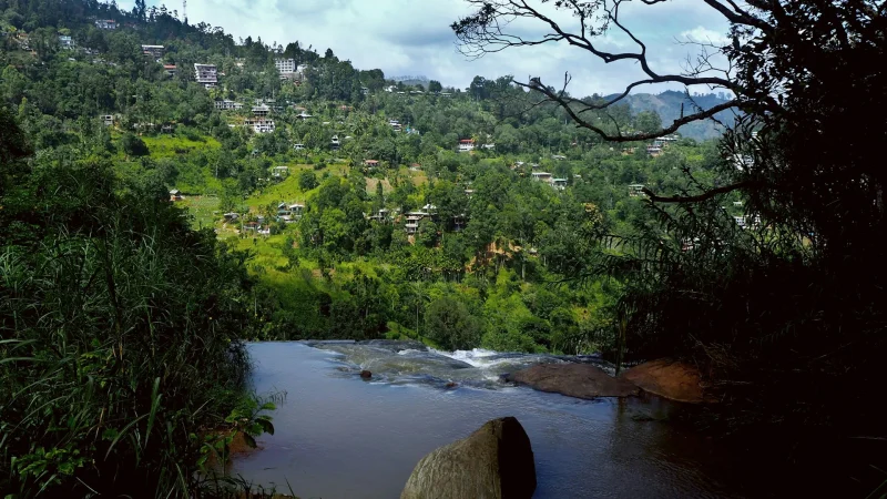 Waterfall and houses on the mountainside of Ella, Sri Lanka